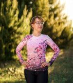Longsleeve damski Sakura LOCO w plenerze, widoczny dopasowany krój, długie rękawy i różowy wzór kwitnących gałązek wiśni.