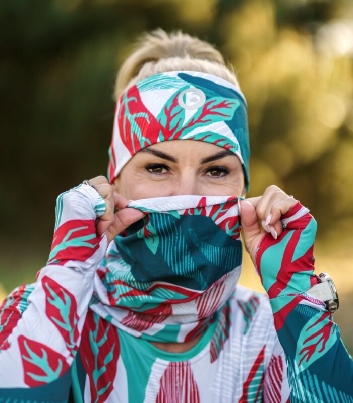 Komin wielofunkcyjny Liściak LOCO nasunięty na usta, modelka w pasującej opasce sportowej w liście.